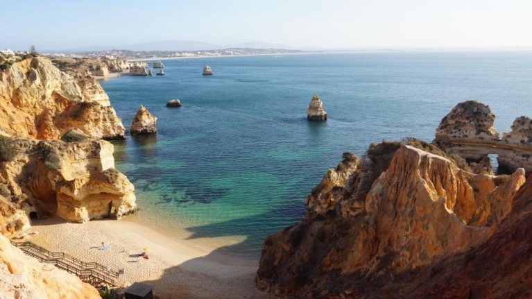 Sun-drenched cliffs, sand and water in Lagos, Portugal