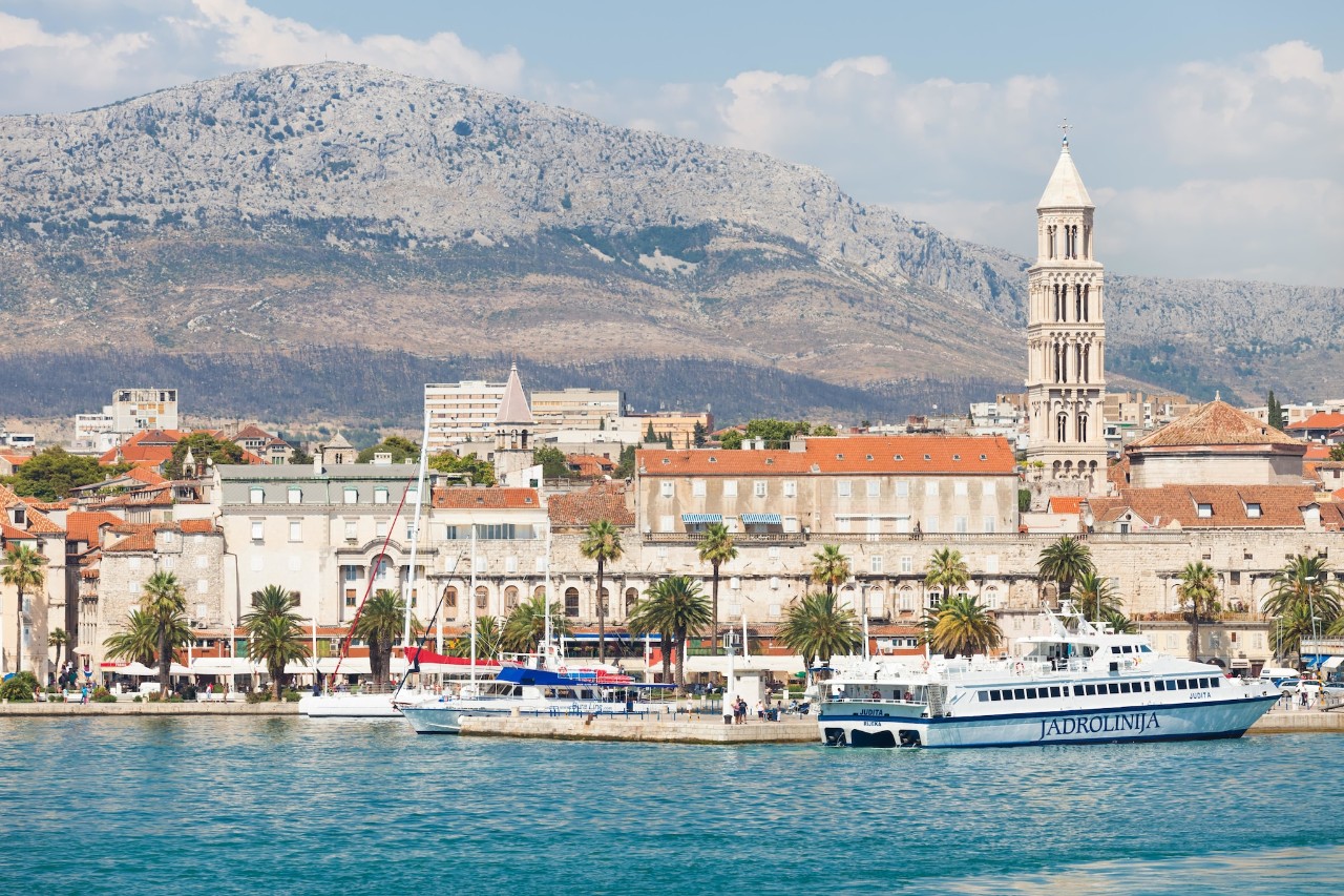 A landscape of Split's harbour with mountains in the background